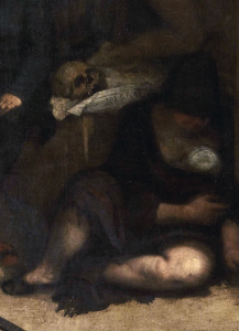 An impoverish figure, laying behind the canvas, is posed by a skull.