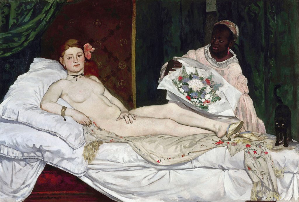 A nude woman laying on a bed of linens and looking at the observer. Next to her is a maid at work (a person of colour) and a black cat. She wears slippers, jewelery, and a flower is tucked behind her ear.