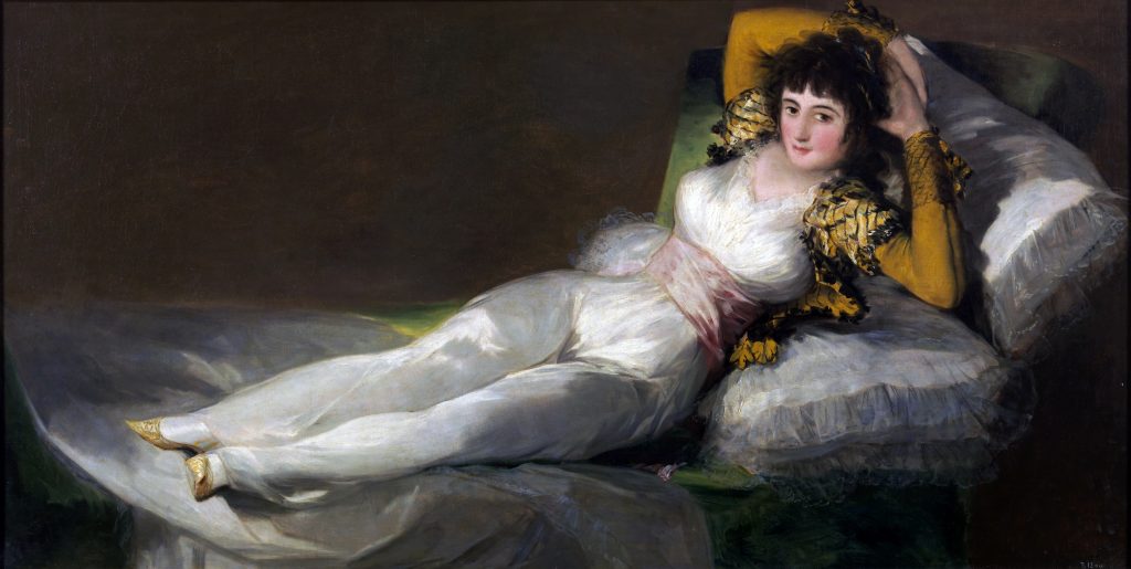 Goya's reclining woman is now dressed in a white silk dress and a vibrant yellow top.