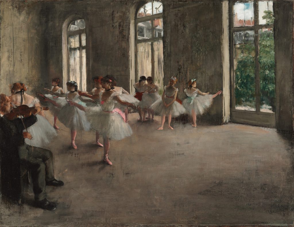 In a room lit by three large windows overlooking a garden, numerous young ballet dancers perform by a musician playing the violin.