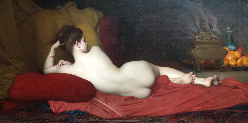 A pale nude woman with a gold bracelet lays on a red tapestry, but we only have access to the back of her figure. Behind her is a tray of oranges and an incense holder.