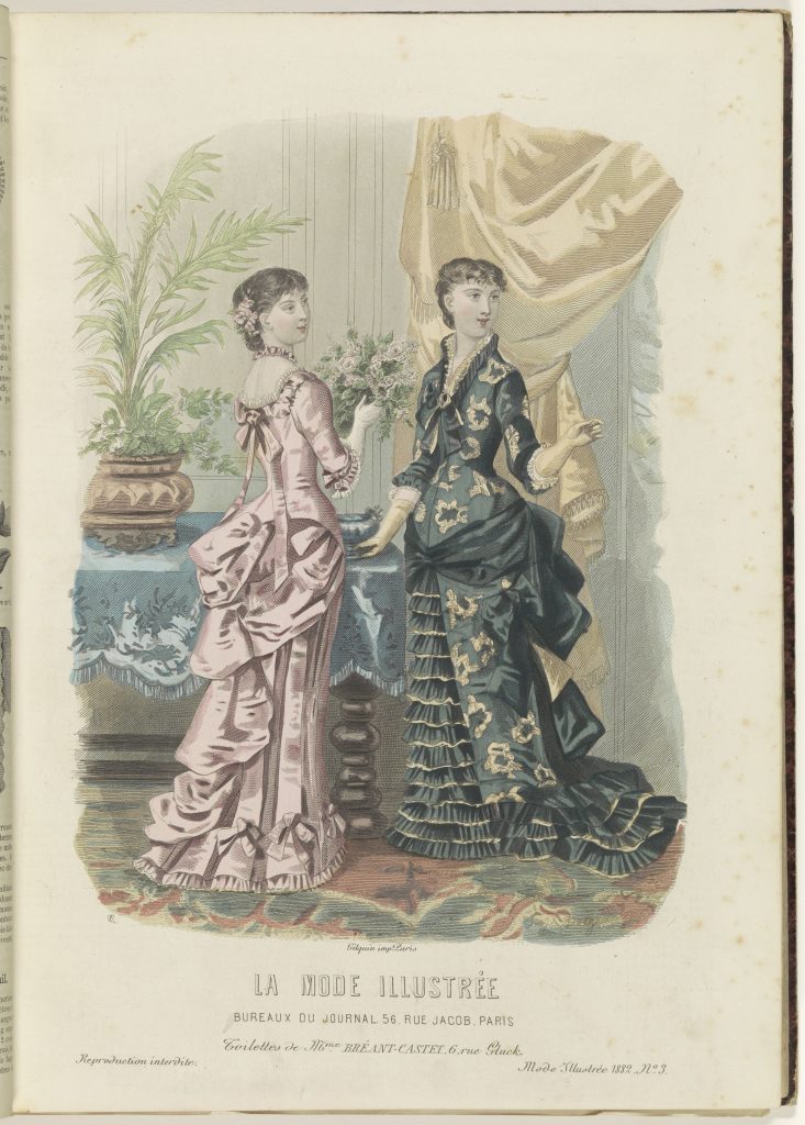 In this fashion plate for La Mode Illustré, two women discuss while clad in intricate vibrant dresses. One holds flowers. They both look rightward, away from the scene.