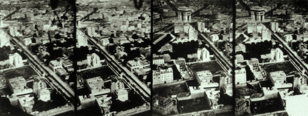 Four shaky photographs form an aerial skyline of Paris. The Arc de Triomphe is in view.