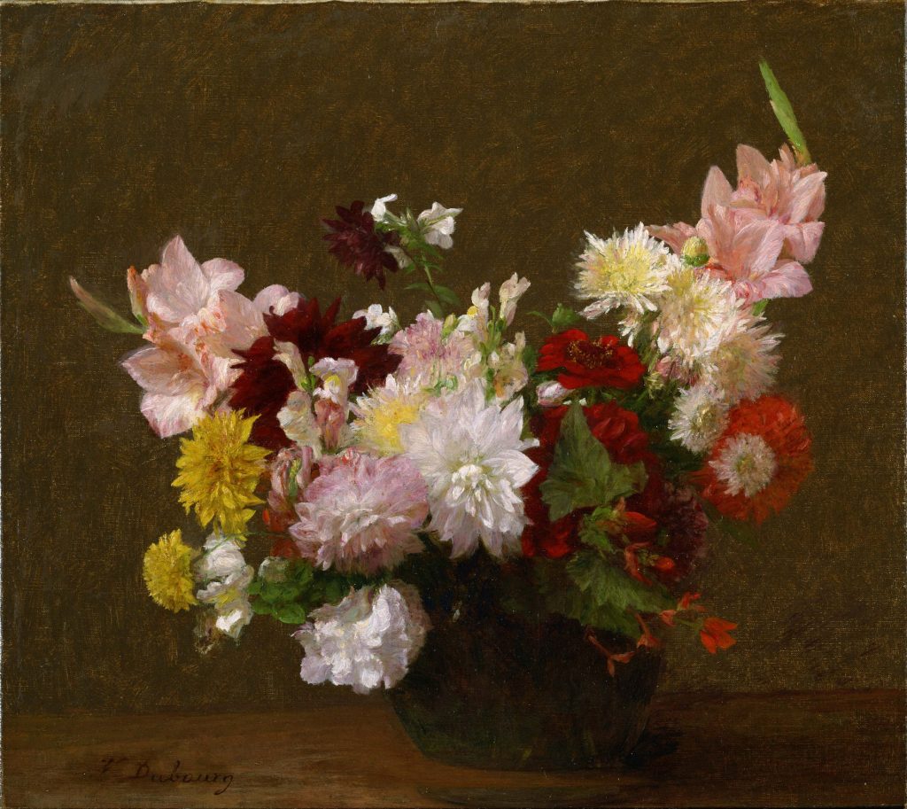 A wide array of flowers of various colours stemming out of a circular vase.