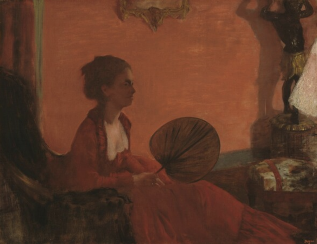 In a painting almost entirely made up of red tones, a woman in an intricate dress holds a fan and leans forward from her armchair.