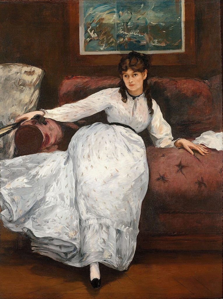 A portrait of a white gowned Morisot, splayed across a red sofa. A japanese print is on the wall behind her.