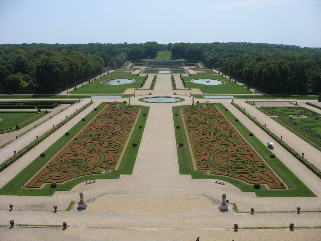 An ornate palace garden where hedge designs have been grown.