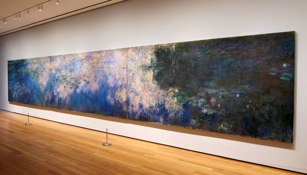 A New York exhibition of Monet's Reflections of Clouds on the Water-Lily on a uniform white museum wall.