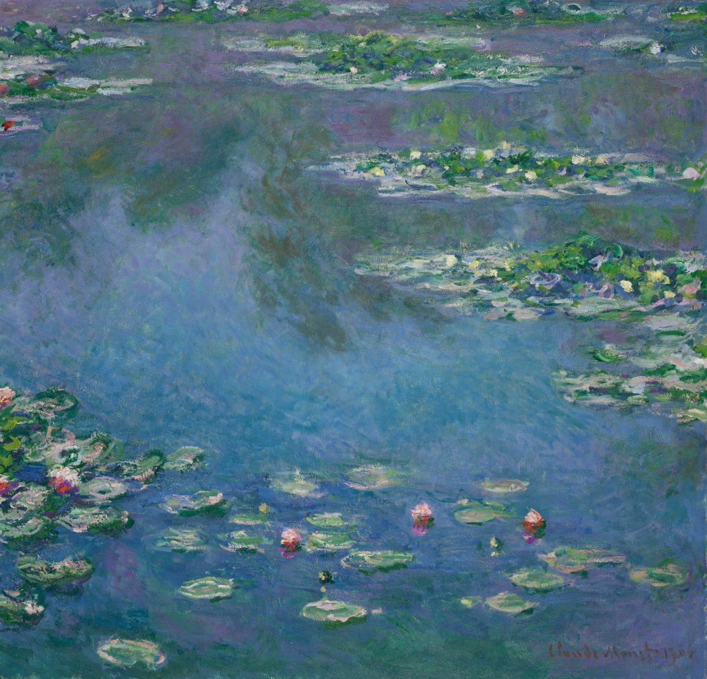 A serene blue pond, adorned with water lilies, reflected a forested area not in view.