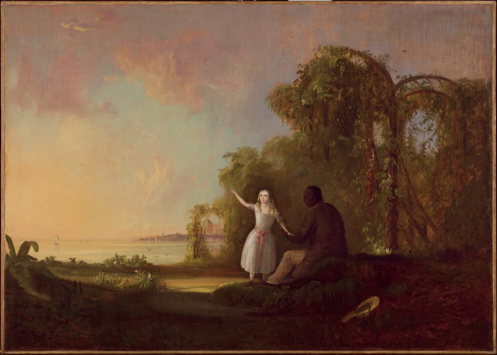A black man, sat on a rock, holds the hand of a young white girl in a light blue dress before a lakeside landscape.