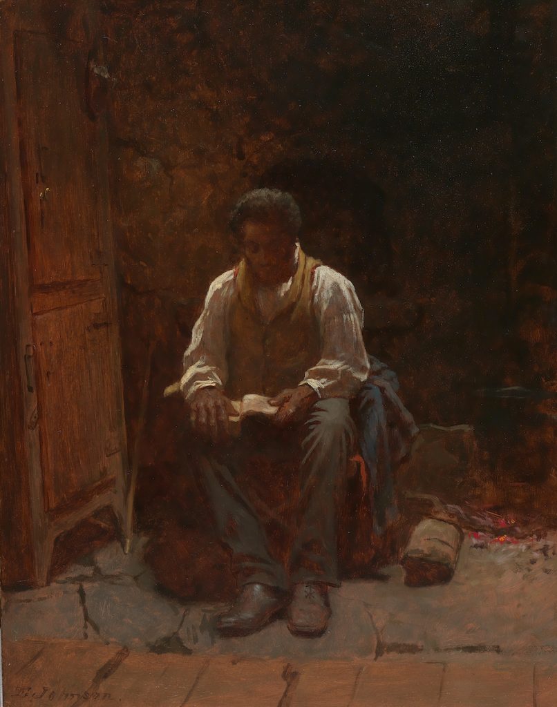 A thickly atmosphered painting of a black man sitting and reading by a wardrobe. A lightly lit interior scene.