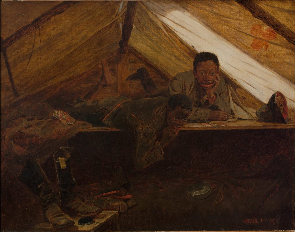 The interior of a tent, light piercing through the fabric, where two black boys lay on their stomachs in blue coats.