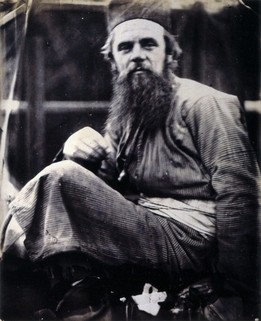 A blurry portrait photograph of William Hunt wearing eastern robes.