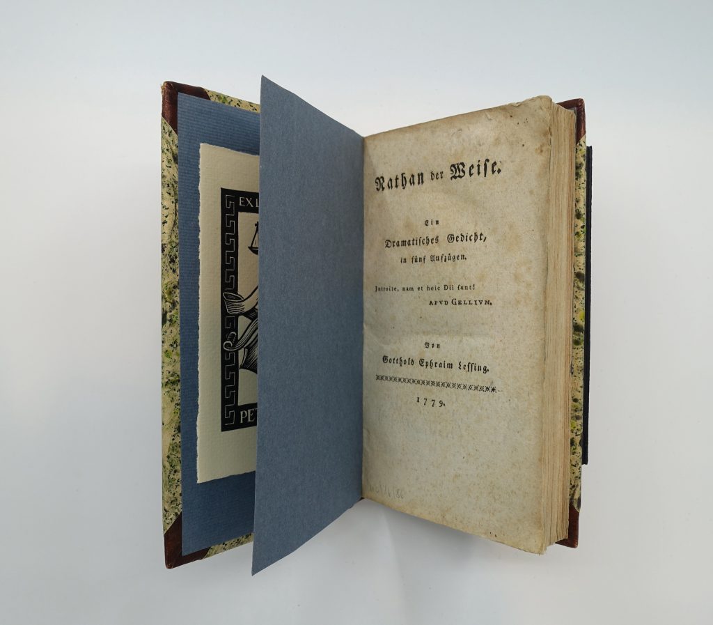 An aged copy of Gotthold Ephraim Lessing's book placed on display, half open to the title page.