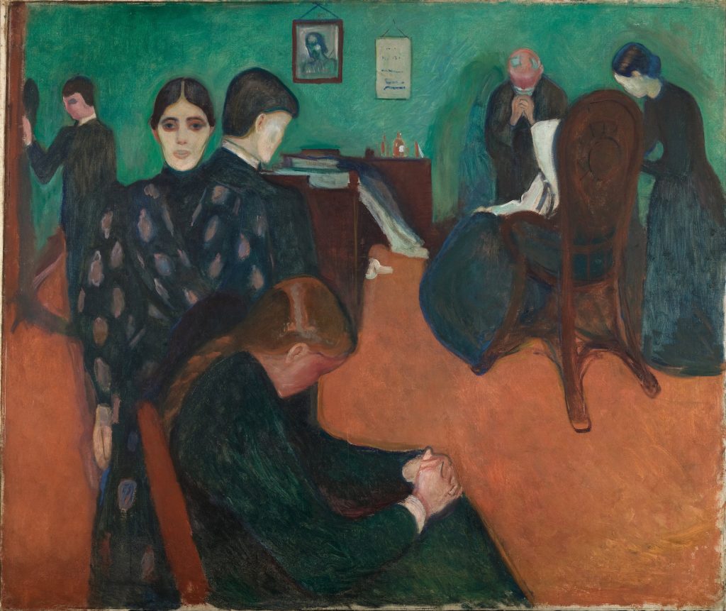 A flat scene in a green-walled room where a group of individuals mourn, some with hands in prayer. One woman returns gaze to us.