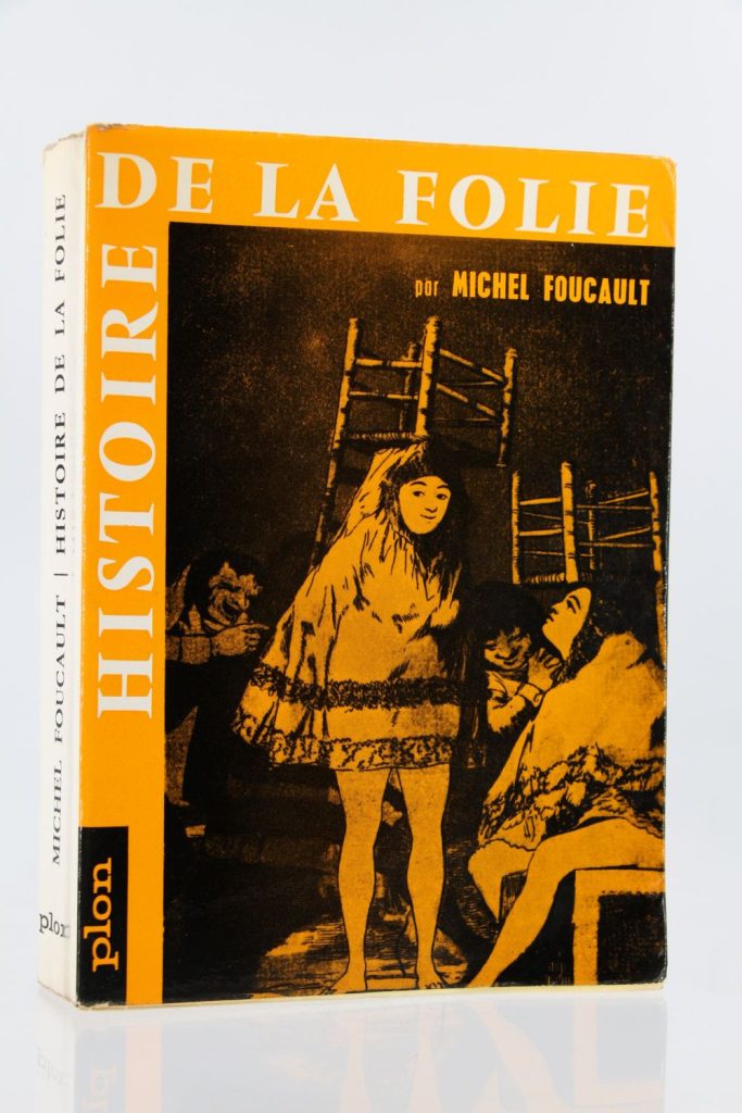 Foucault's orange and darkly tinted novel is covered by figuration of women holding chairs on their heads. There are personnifications of madness in the art-work.