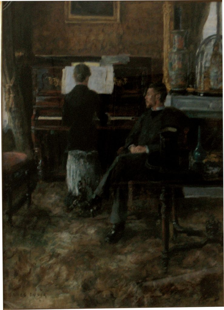 A woman plays the piano by her teacher, sat comfortably in a chair, by her side. The room is filled with furniture and clad with art.