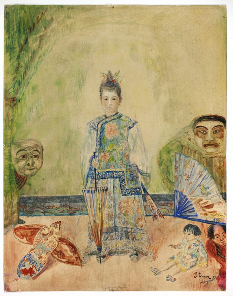A young girl in a kimono stands in a pale room flanked by masks and other trinkets of chinoiserie.