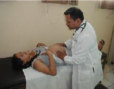 Pregnant woman with braided hair laying down on a hospital bed while a doctor is touching her belly