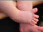 A baby's right foot spreading its toes