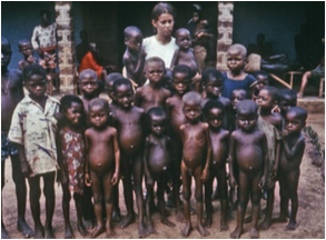 Naked African children and White woman posing for a photo
