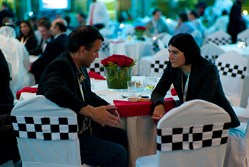 A photograph of two people making eye contact during a conversation.