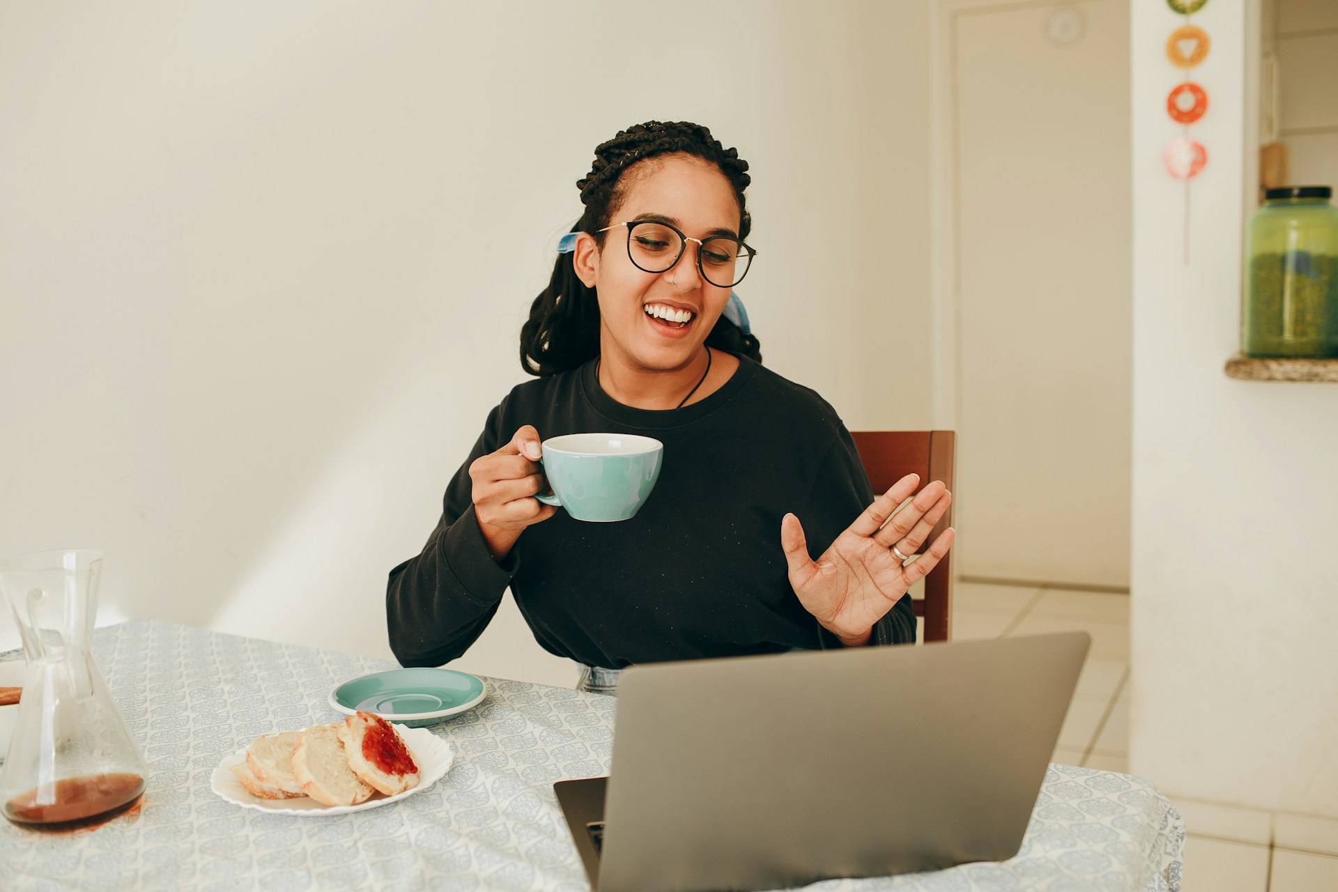A person smiles as they video call with their family.