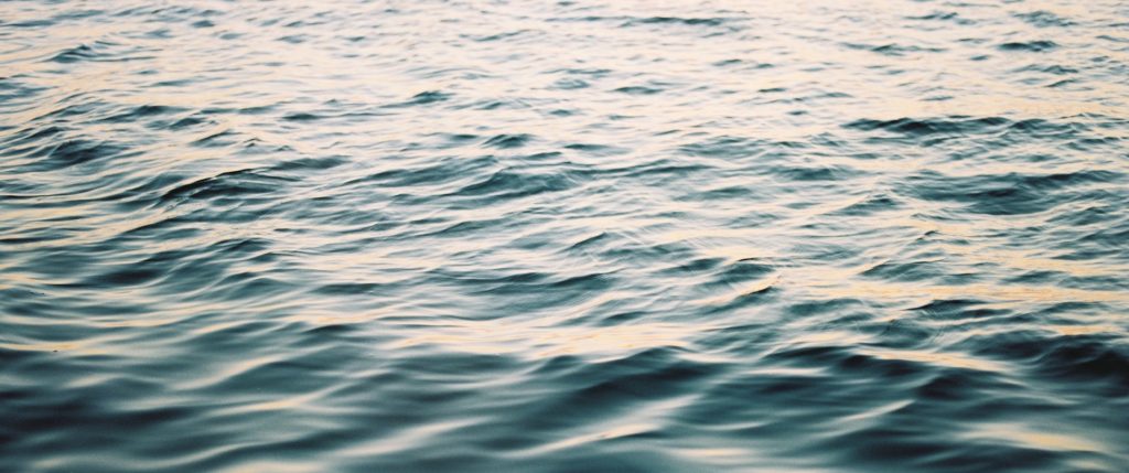 Close-up view of dramatic shadows on surface waves of the Kaniatarowanenneh (St. Lawrence seaway) running through Tiothiá:ke (Montreal).