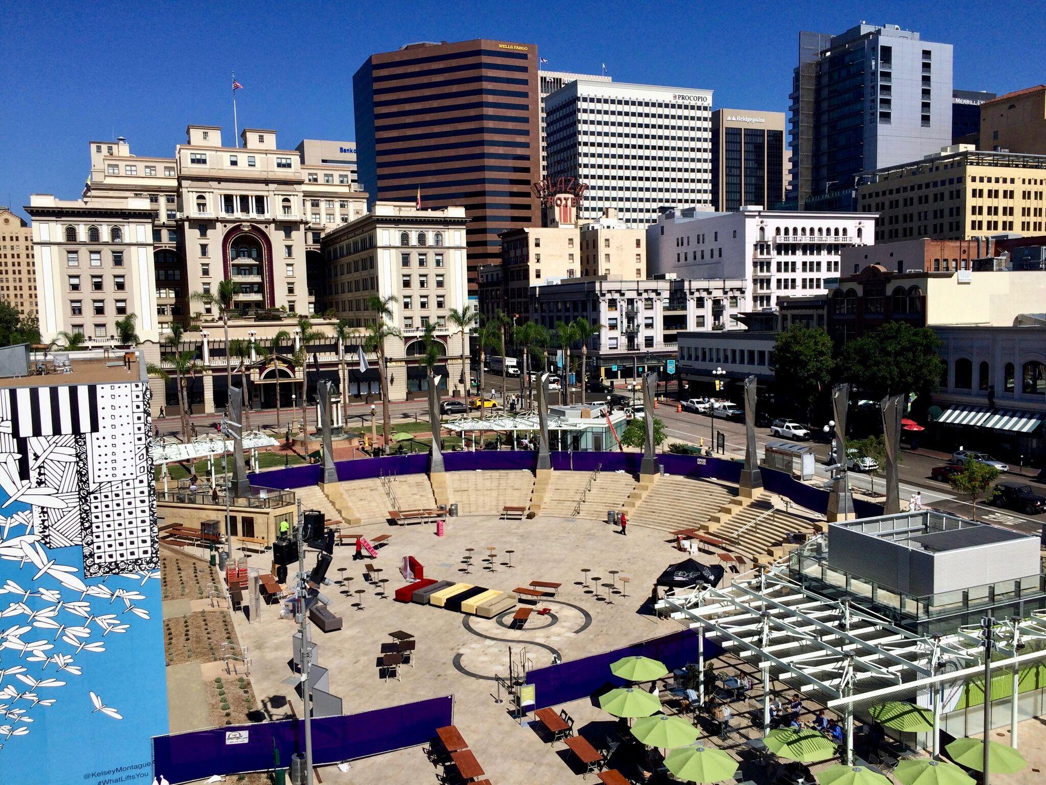 Multistory buildings surrounding a greek-style plaza.